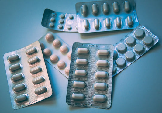 Probiotic supplement capsules on a plain background